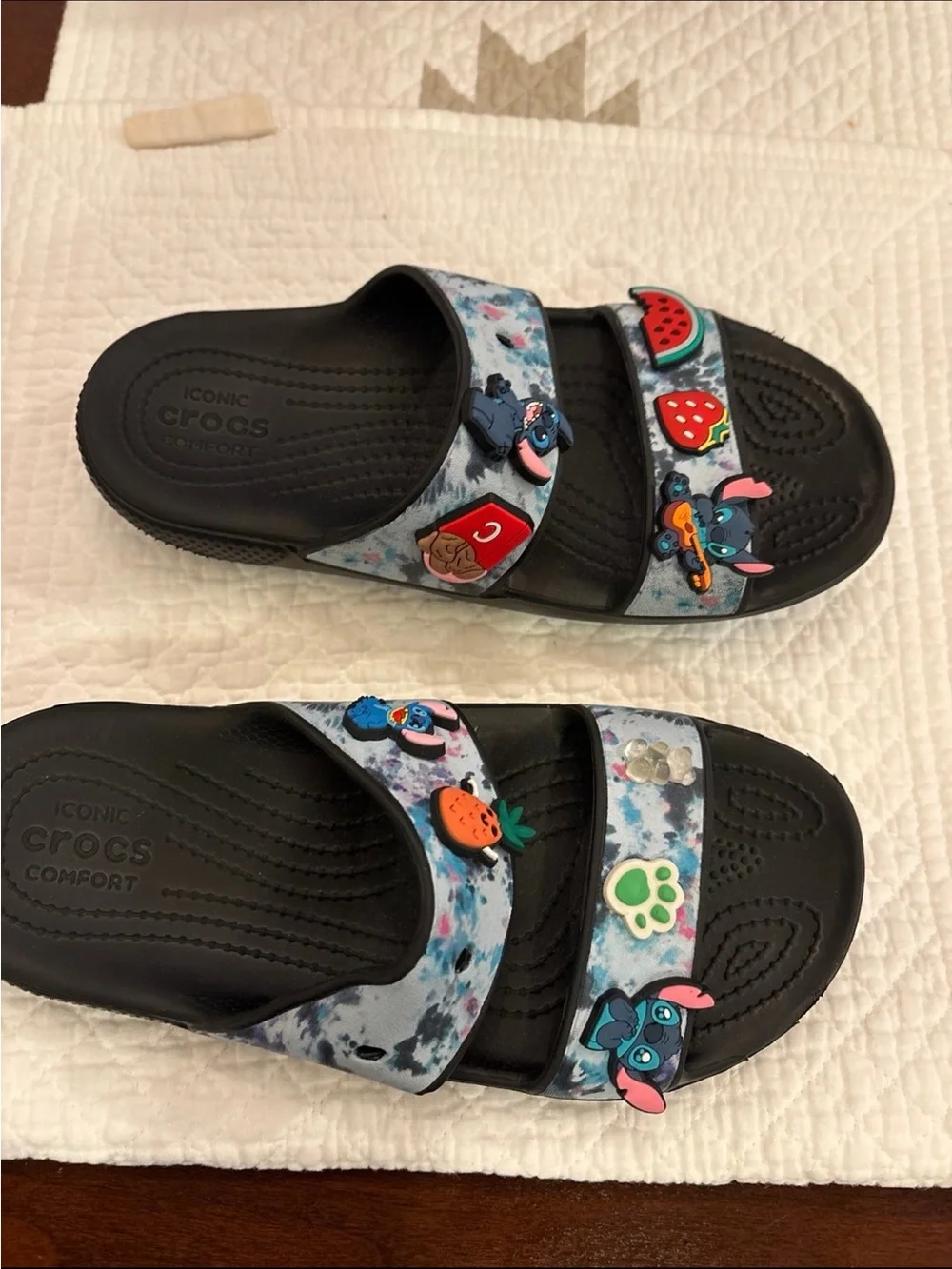 CROCS Kids Black Slide Sandals with Blue Tie-Dye Straps and Colorful Charms
